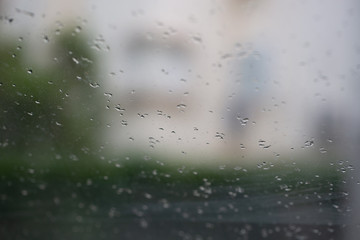 rain drops on window. Drops on a glass surface and dripping down. background water drops on the glass / wet window glass with splashes and drops of water and lime, texture autumn background