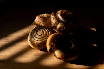 delicious bagels with poppy seeds  lie on a wooden Board, warmly illuminated by a beautiful warm light.