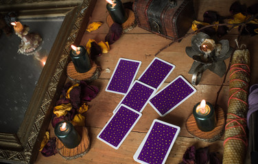 Tarot cards and other magic attributes for rituals and fate prediction, details on a table of...