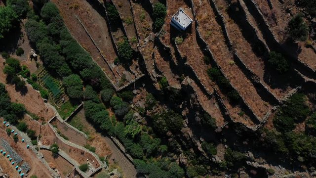 Aerial top down shot of a trademark cycladic landscape, rocky and wild. Sifnos island, Greece.