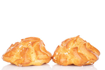 Group of two whole fresh baked profiterole isolated on white