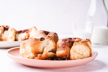 Cinnamon buns   in plate on morning table