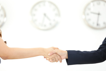 businessman and businesswoman holding clock