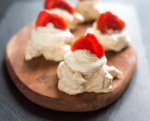 gourmet dessert pavlova strawberry on a wooden background