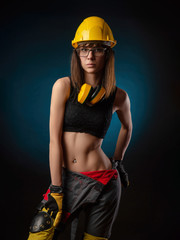 Girl in overalls with a chainsaw