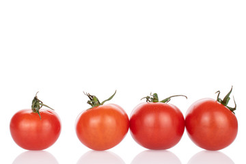 Group of four whole fresh red cherry tomato isolated on white