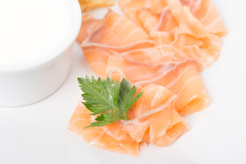 Fragment of breakfast with salmon and blinis.