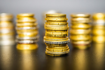 Stacks of euro coins on black table
