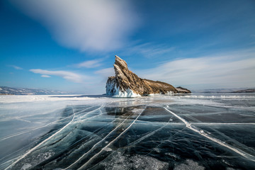 Ogoy island on lake Baikal in winter, transparent ice with cracks - obrazy, fototapety, plakaty