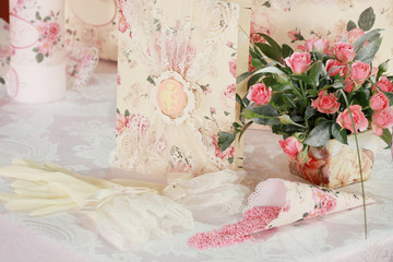 table setting at white wedding reception, floral composition, candles and cones, lights on the background