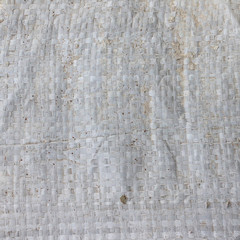 the texture of the bag in the grid. light green binding of thin plastic. plastic bag for cottages, potatoes, garbage. background with a bag filling pattern