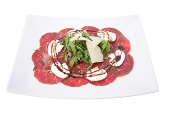 Carpaccio meat with parmesan cheese and arugula.
