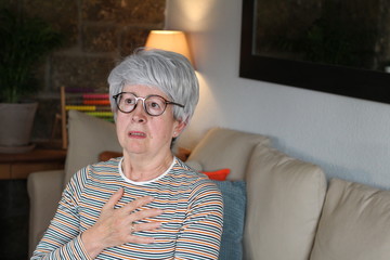 Shocked and dramatic senior woman