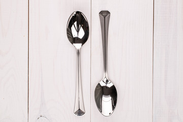 Group of two whole spoon on white wood