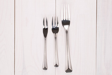 Forks on white wood