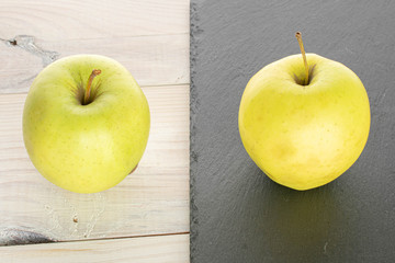 Group of two whole green delicious apple on stone and on white wood