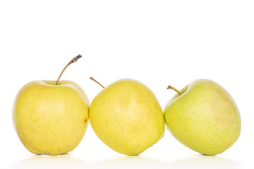 Group of three whole green delicious apple isolated on white