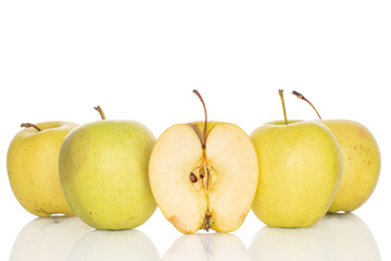 Group of four whole one half of green delicious apple isolated on white