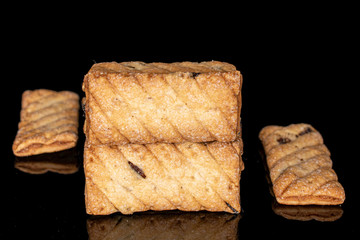 Lot of whole flat square puff cookie with raisins isolated on black glass