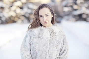 winter girl in a fur coat portrait outside, beautiful white fur coat