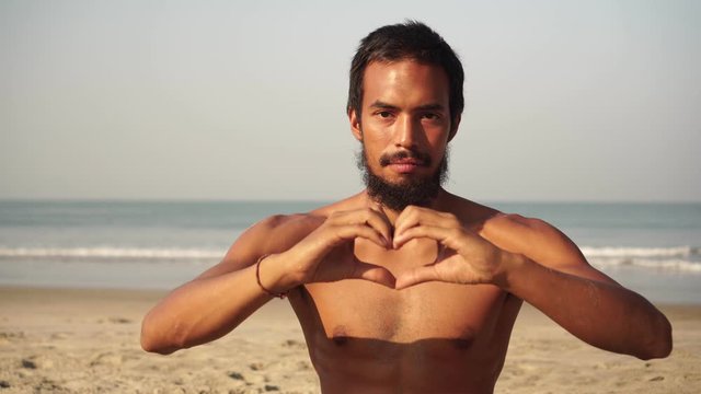 Male yogi folded his hands in the shape of a heart. Love and harmony