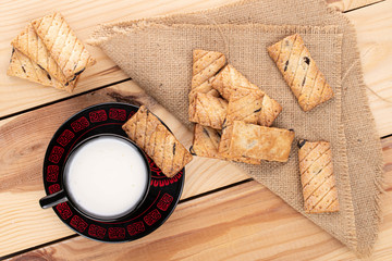 Lot of whole square puff cookie with raisins for breakfast on wood