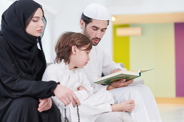 muslim family reading Quran and praying at home