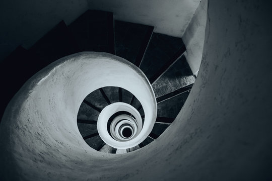 Black And White Image Of Spiral Stairs Looking Down From The Top, Creating An Interesting Perspective. 