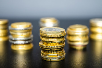 Stacks of euro coins on black table