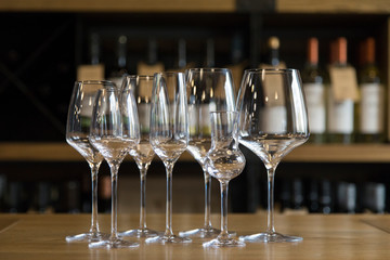 A number of glasses on the bar.