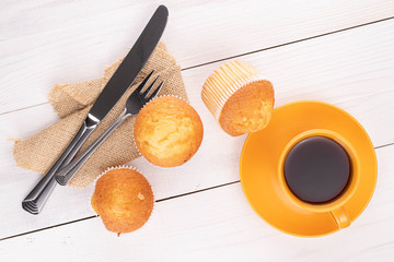 Group of three whole small baked muffin breakfast on white wood