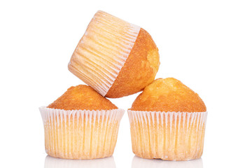 Group of three whole small baked muffin isolated on white