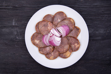 Meat plate with meat stock with red onions