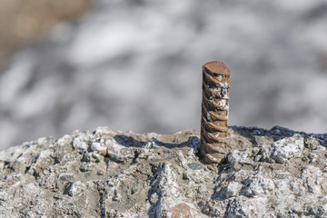 Metal rebar stick out of concrete plate. Selective focus