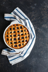 Homemade American cherry pie. Very tasty. On a dark background, top view, side view. Space for text.