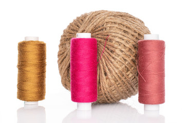 Group of four whole thread spools isolated on white