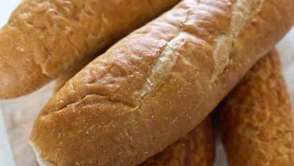 Fresh bread, french baton, tiger bread and small baguettes close up, with shallow depth of focus