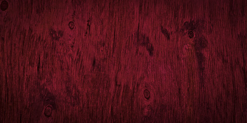 Dark burgundy wood texture. Texture of old dried plywood. Mahogany background for design.