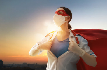 Doctor wearing facemask and superhero cape