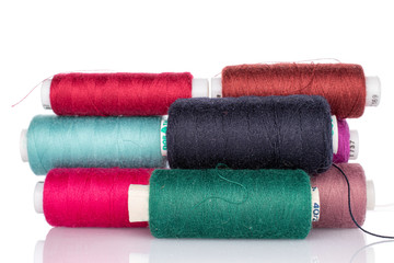 Lot of whole thread spools stack isolated on white