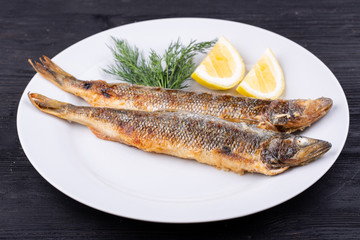 Mackerel fried on grill, served with lemon and dill