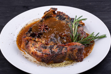 Fried pork meat baked in an oven with sauce and spices