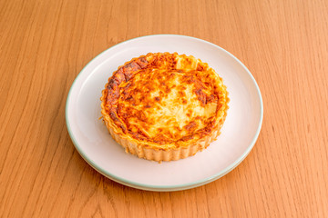 white plate with three cheese quiche