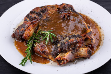 Fried pork meat baked in an oven with sauce and spices