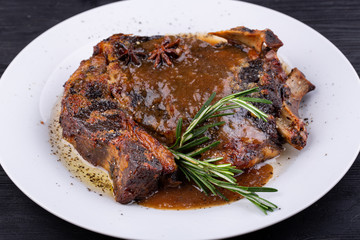 Fried pork meat baked in an oven with sauce and spices