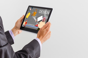 Man hand working with tablet illustration project at home while relaxing on couch. Back view of latin architect reading illustration on digital tablet.