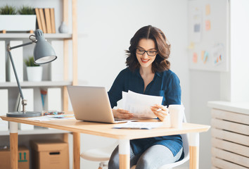 Woman working on a laptop.