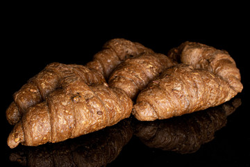 Lot of whole baked wholegrain croissant isolated on black glass