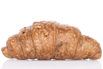 One whole baked wholegrain croissant isolated on white