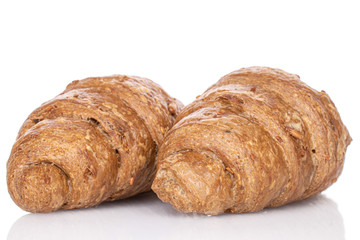 Group of two whole baked wholegrain croissant isolated on white
